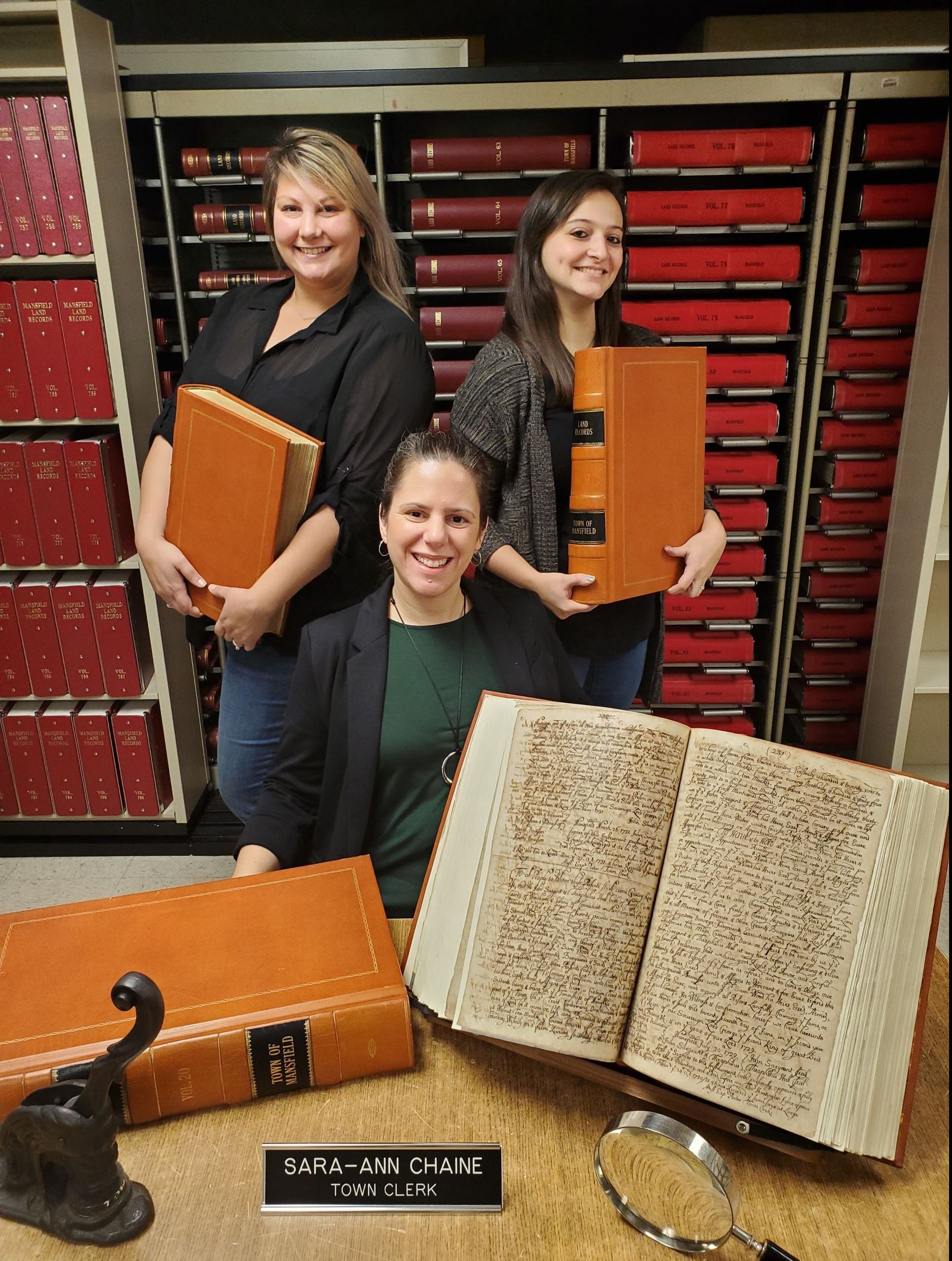 Town Clerk staff holding books and records