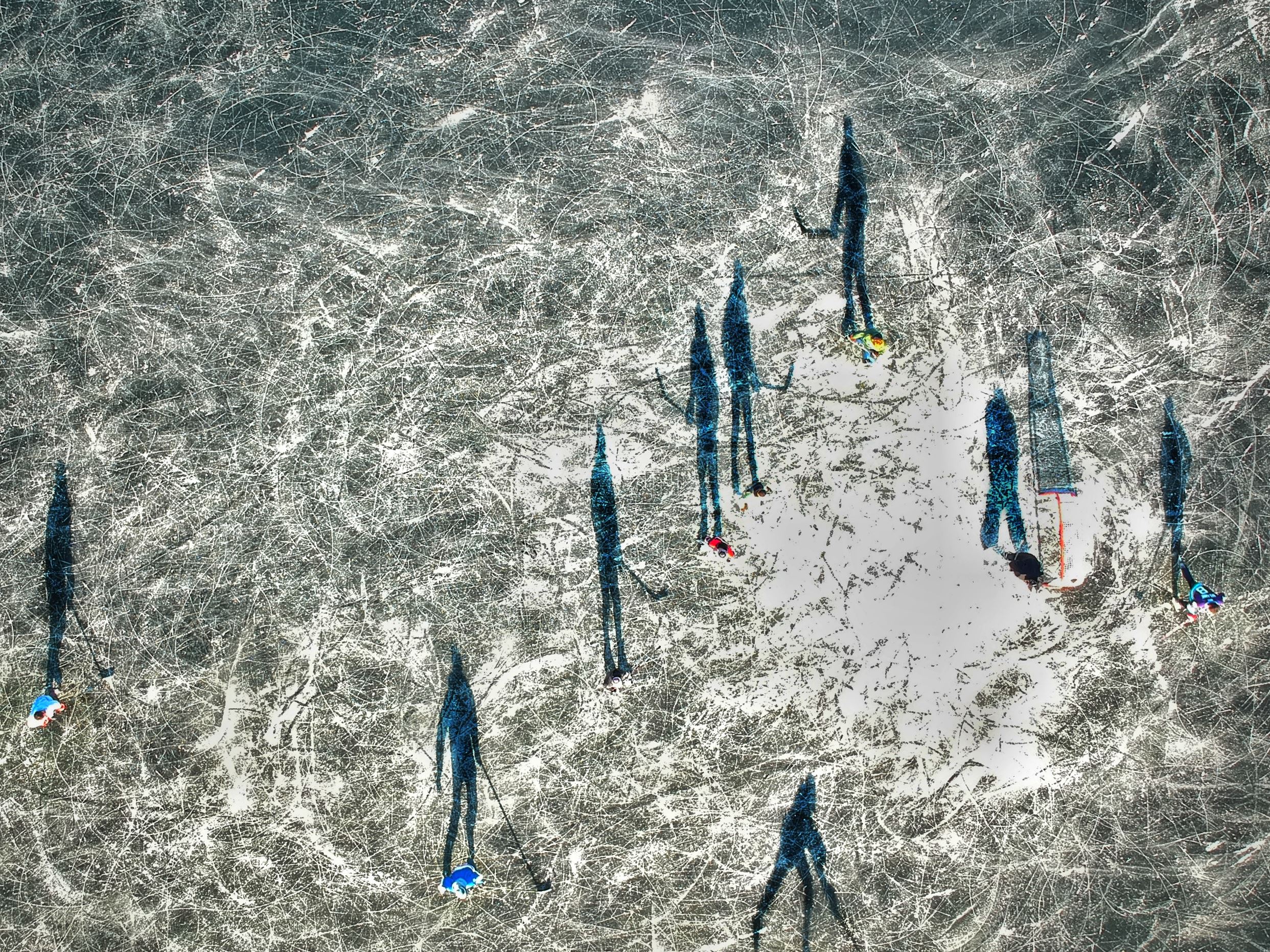 People playing ice hockey on a frozen pond